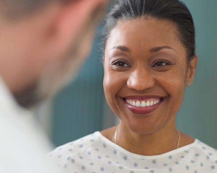 Female patient smiling at her physician