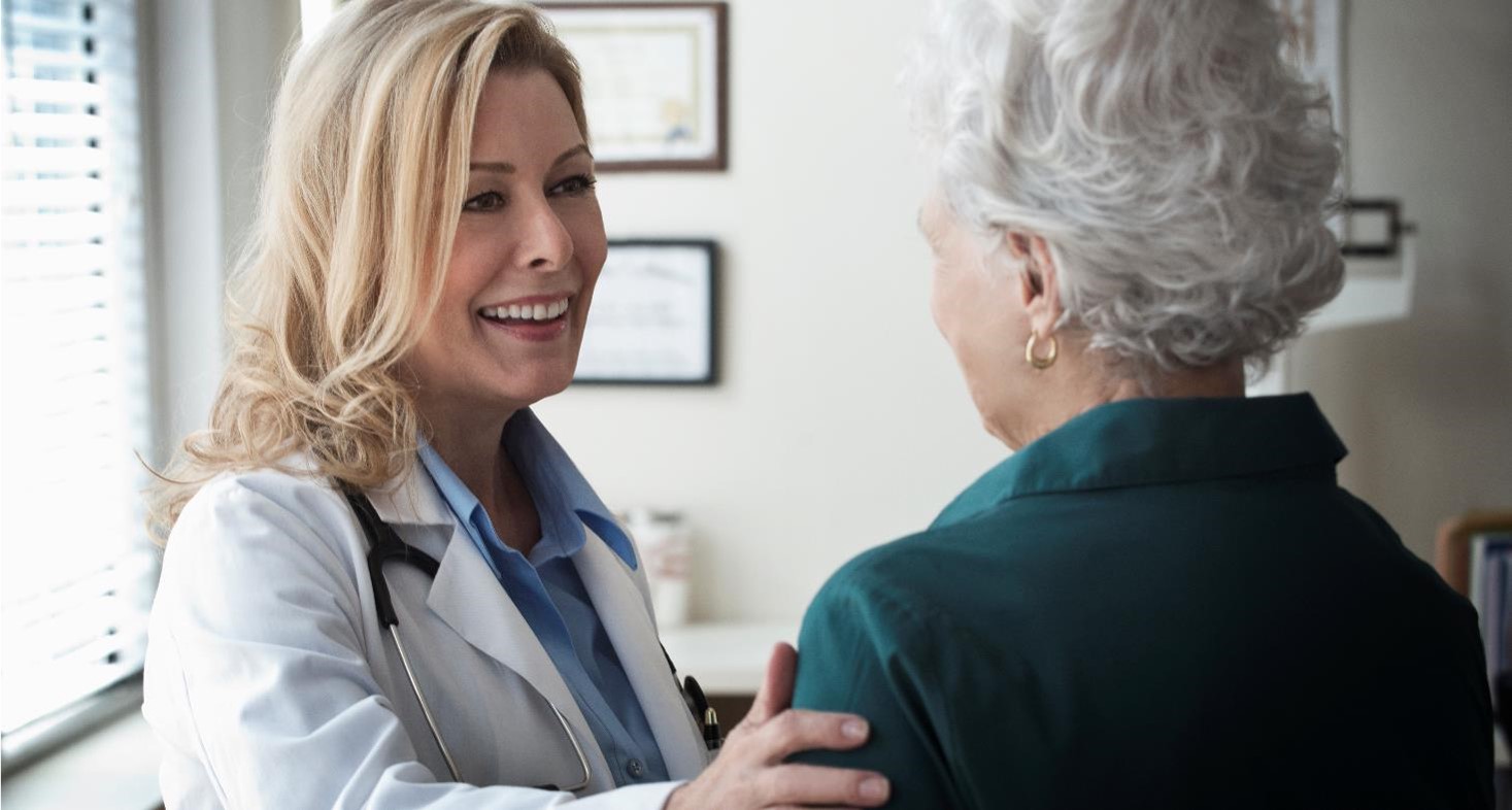 Female doctor talking to a senior patient in clinic